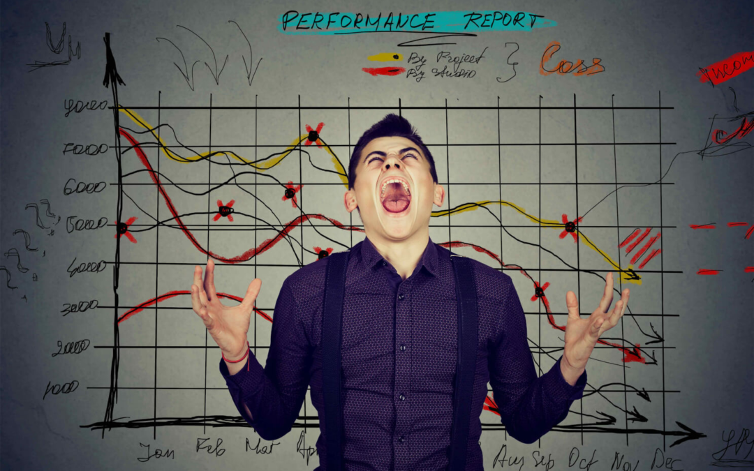 An image of a young and stressed manager in front of a sales chart showing things have all gone wrong