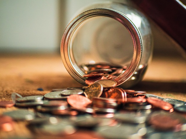 A jar of coins on its side with coins spilling out. If you don't have the profit you expected at the end of a project, it's likely that your margins are askew. Here's how to put that right